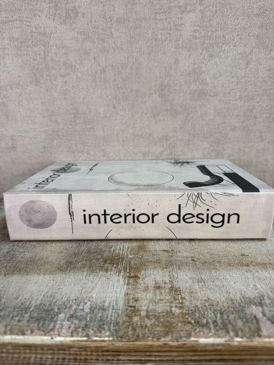 Beige opbergboek van Homebound met zwarte Interior design-print en een bruin opbergvak aan de binnenzijde.